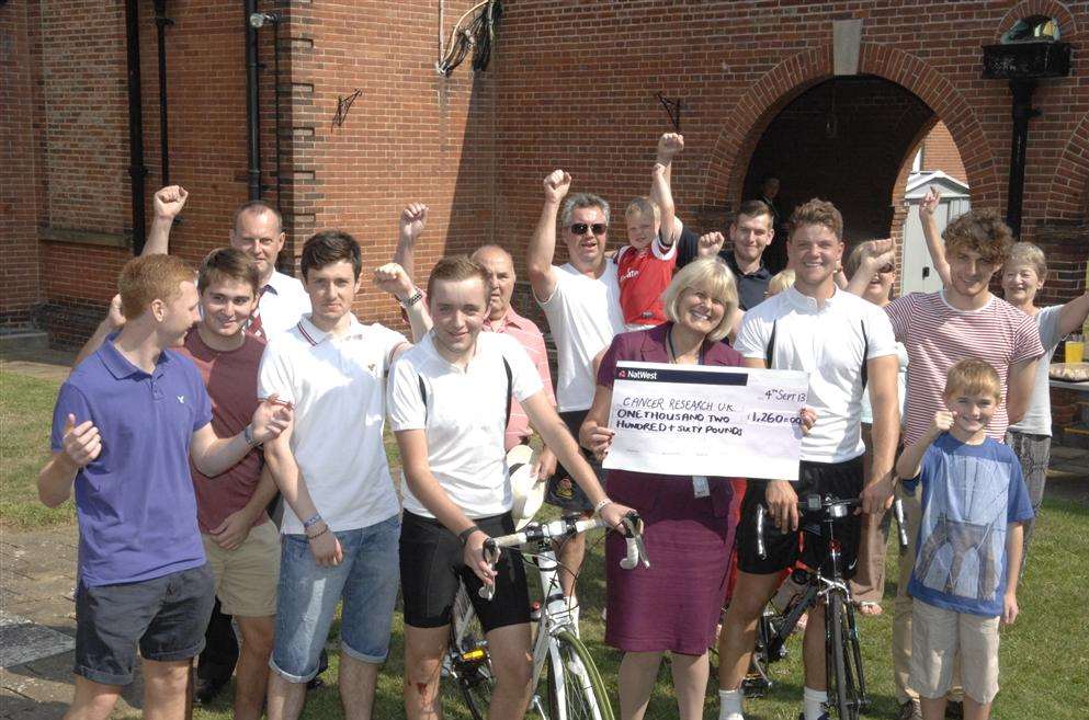 Marcus Underdown and Daniel Pumfrett, who cycled from London to Borden Grammar School in honour of former head teacher Harold Vafeas with deputy head Laurel Townend, family and friends