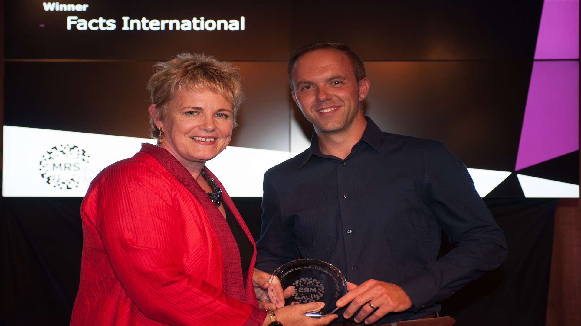 Market Research Society chief executive Jane Frost presents the award to Facts International's field director Adam Wyles