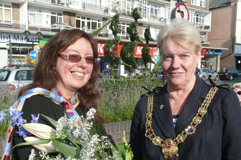 Brighter Dover chairman Sylvie Parsons presents a bouquet to Dover Mayor Cllr Ronnie Philpott after she unveiled the nautical-themed topiary in the Market Square.