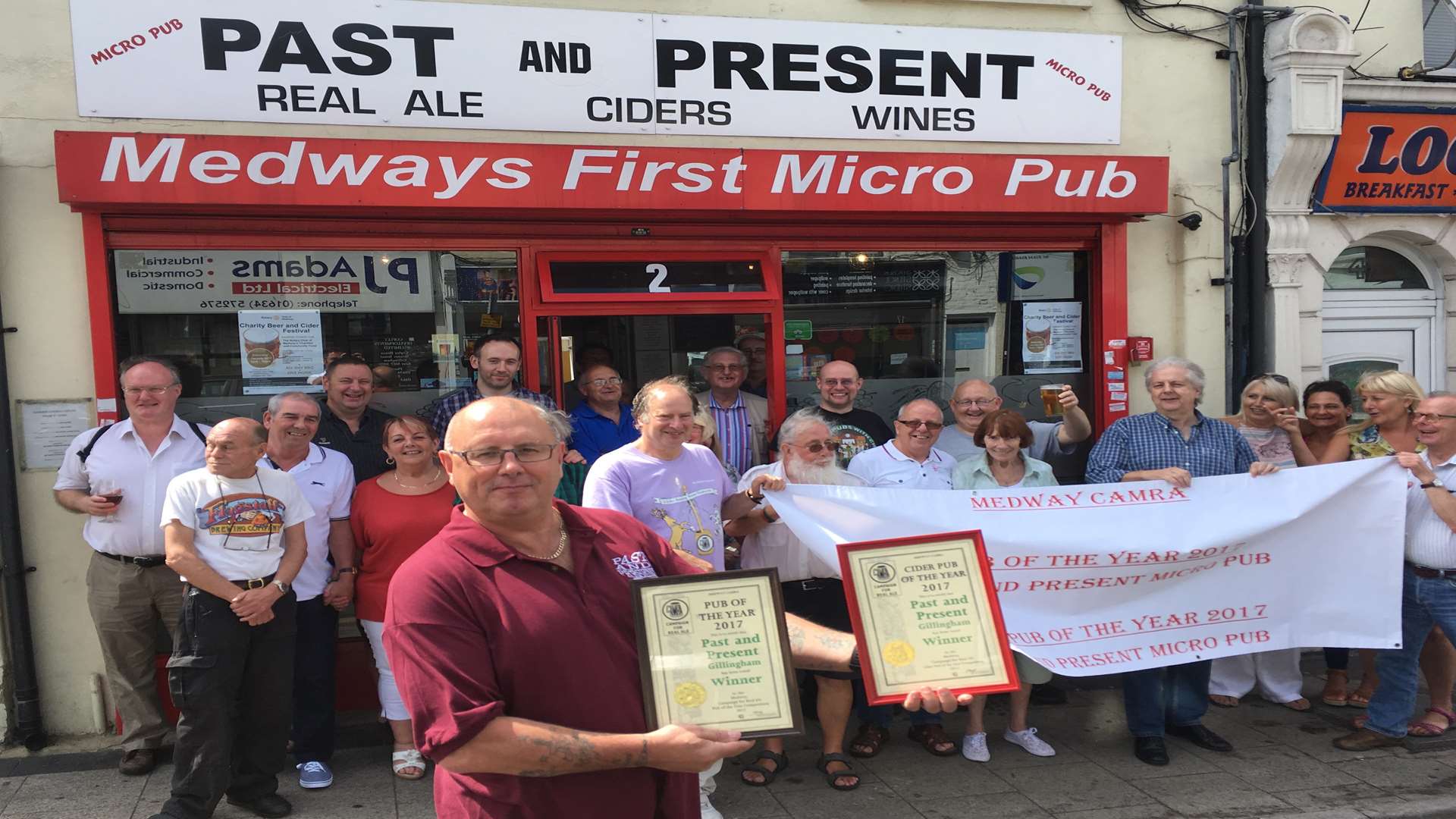 Past and Present micropub landlord Dave Hallowell shows off the awards from CAMRA for Medway's best pub and best cider pub