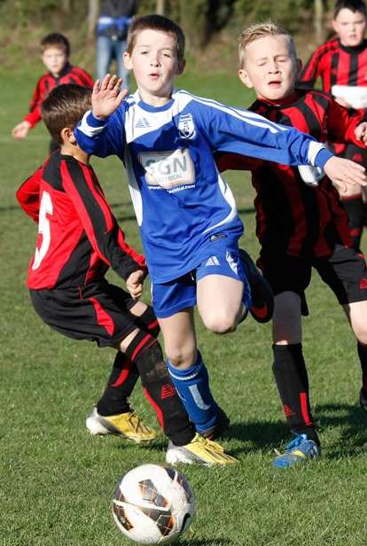 New Road Giants, in blue, take on Woodcoombe Youth Athletic in Under-10 Division 3. Picture: Darren Small