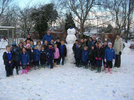 The children of West Malling CEP School with their snowman on Thursday. It was one of the few schools open. Picture courtesy head teacher Darren Webb