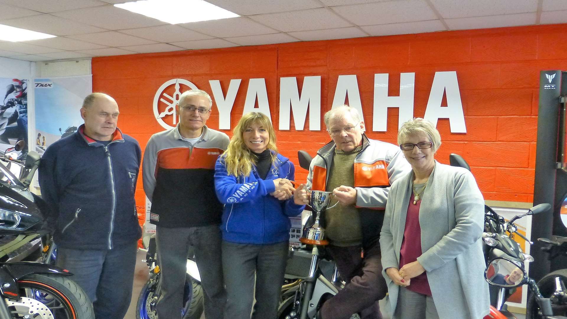 Tony (second from right) is retiring after 40 years at the Yamaha bike shop in the Mall, Faversham.