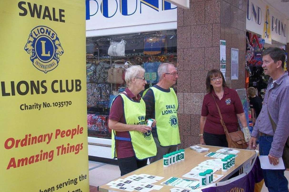 Swale Lions' volunteers speak to a man about the Message in a Bottle scheme