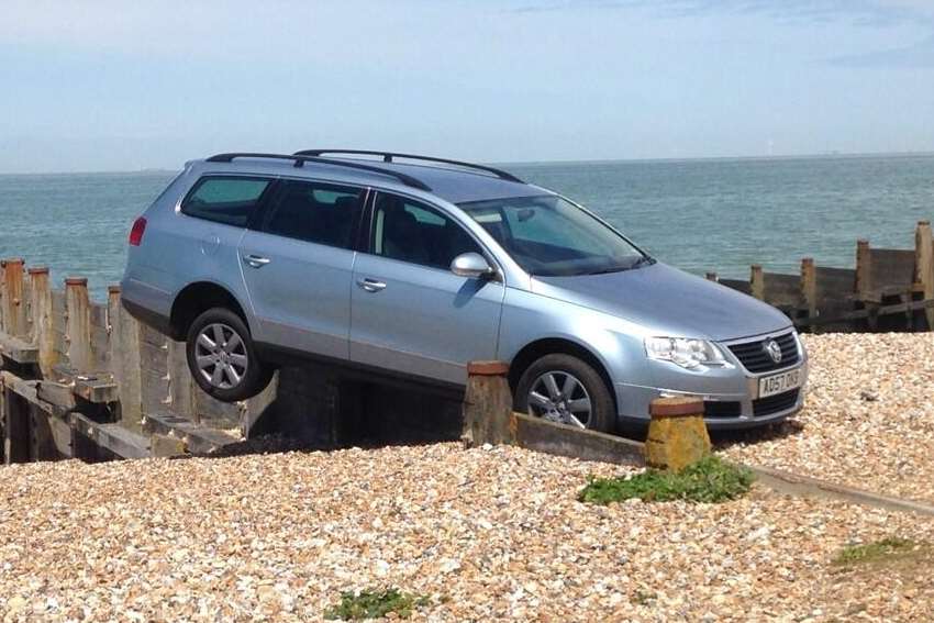 A car teeters on the edge of a groyne at Whitstable. Picture: @Chad_Rivers24