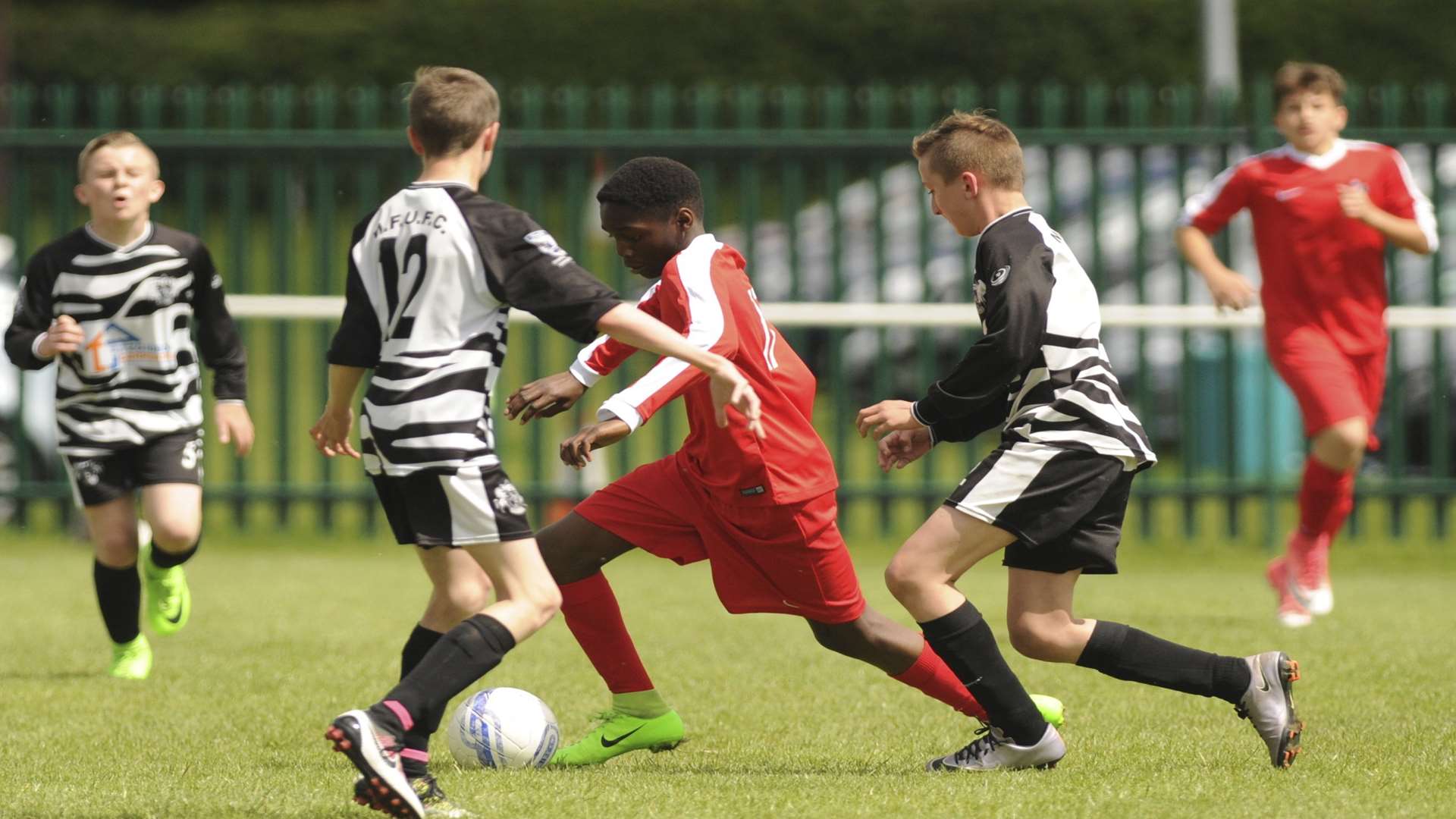 Rainham Kenilworth (red) take the game to Milton & Fulston United in the Under-13 League Cup final Picture: Steve Crispe