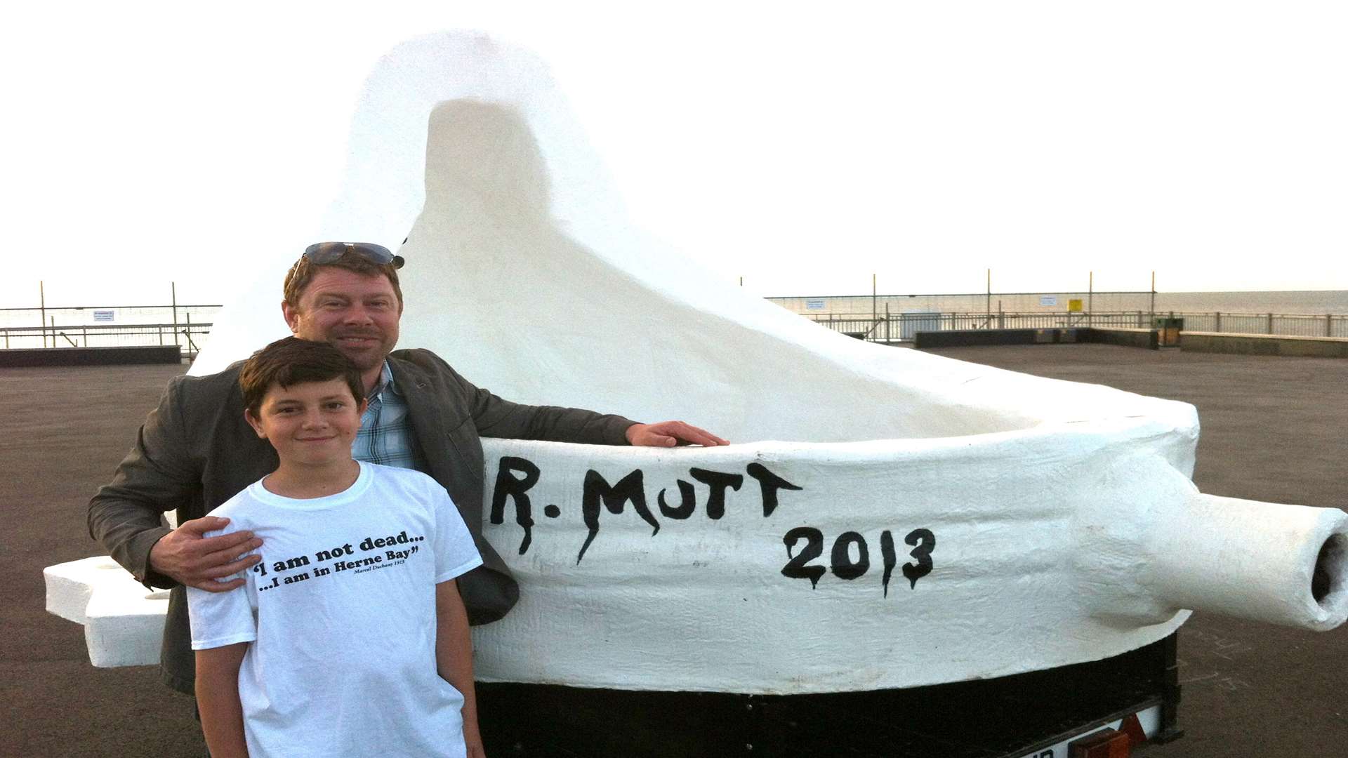 Artist Phillip Long and son Rudi with the Duchamp-inspired urinal on Herne Bay Pier