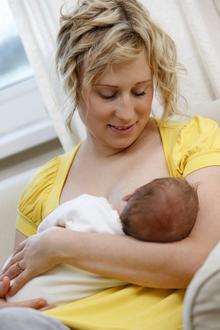 A young mother breast feeds her new born baby. File picture