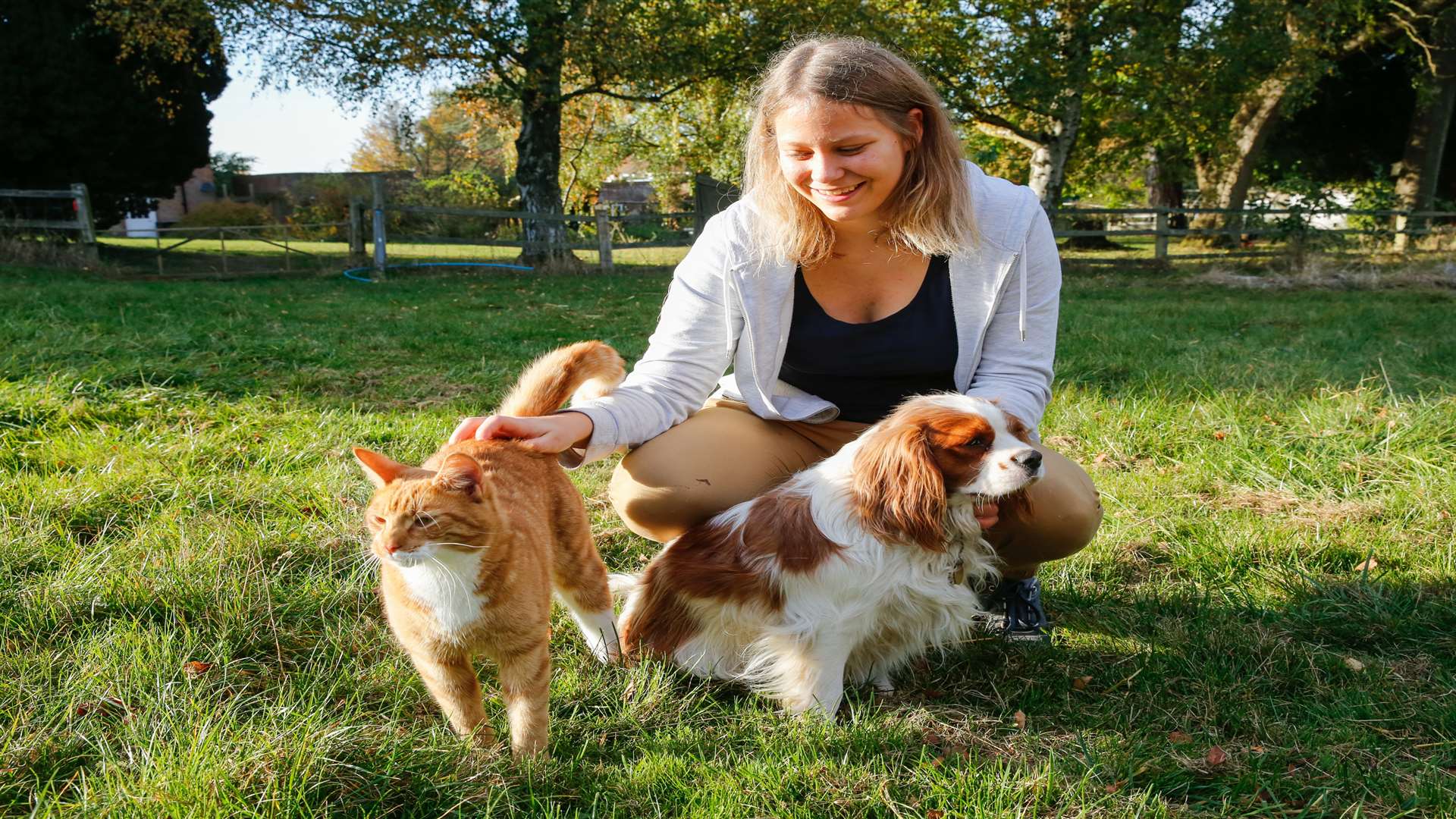 Volunteer Imke Dreyer with Archie the king Charles spaniel and Basil the ginger cat who are pals. Picture: Matthew Walker
