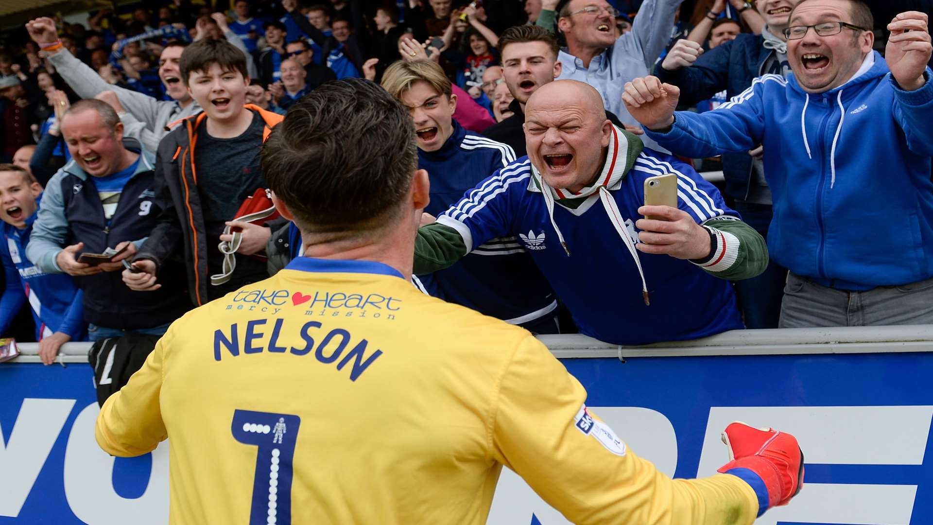 Stuart Nelson savours League 1 survival with the Gills fans at Northampton Picture: Ady Kerry