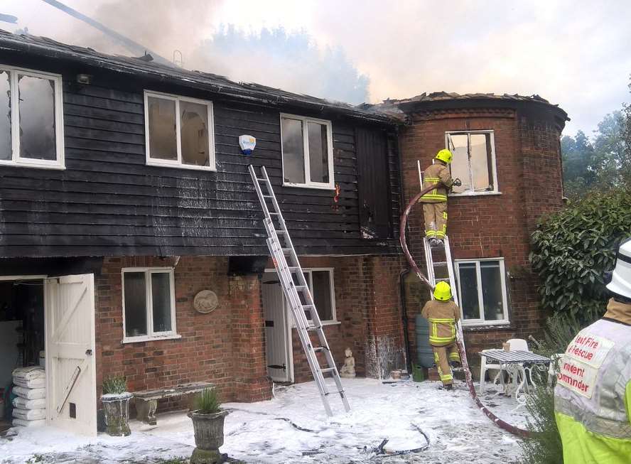Firefighters at the scene of the house blaze in Tudeley. Picture: Kent Fire and Rescue.