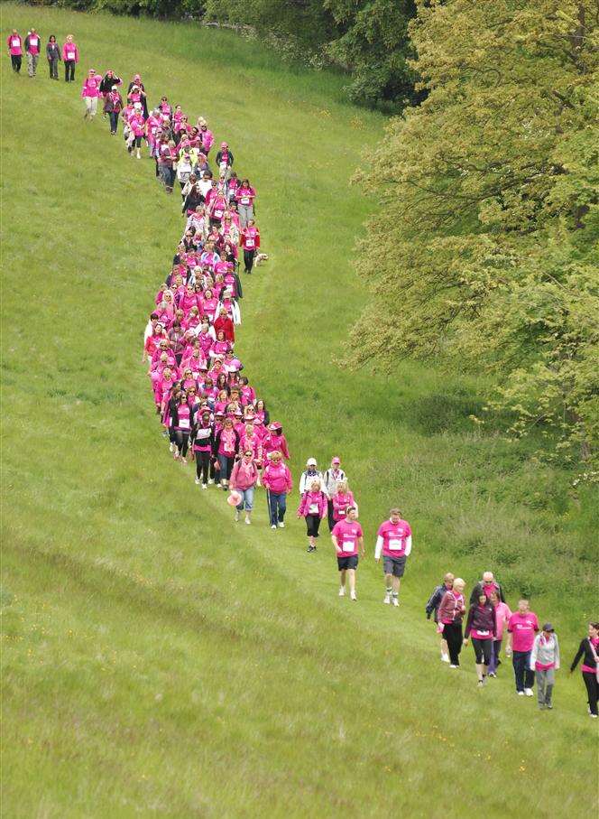 Walkers fill the grounds of Leeds Castle with pink