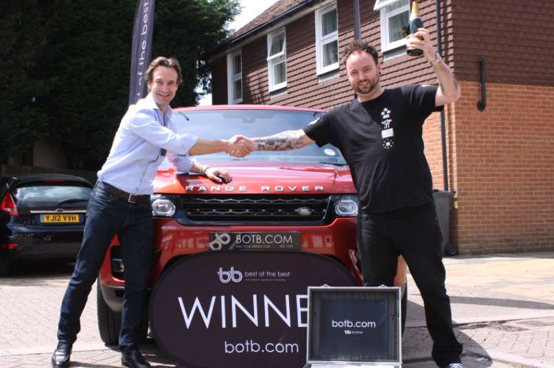 Will Hindmarch, CEO of BOTB handing over the keys to a new Range Rover Sport to winner Rikki Tronson