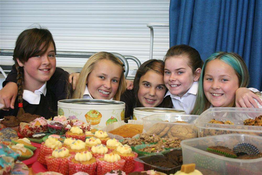 Year 6 girls serve cake to raise funds for Macmillan Cancer Support at Bromstone Primary School, Broadstairs.