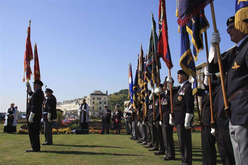 Standard bearers line up for the wreath laying ceremony at the Merchant Navy war memorial on Dover seafront.