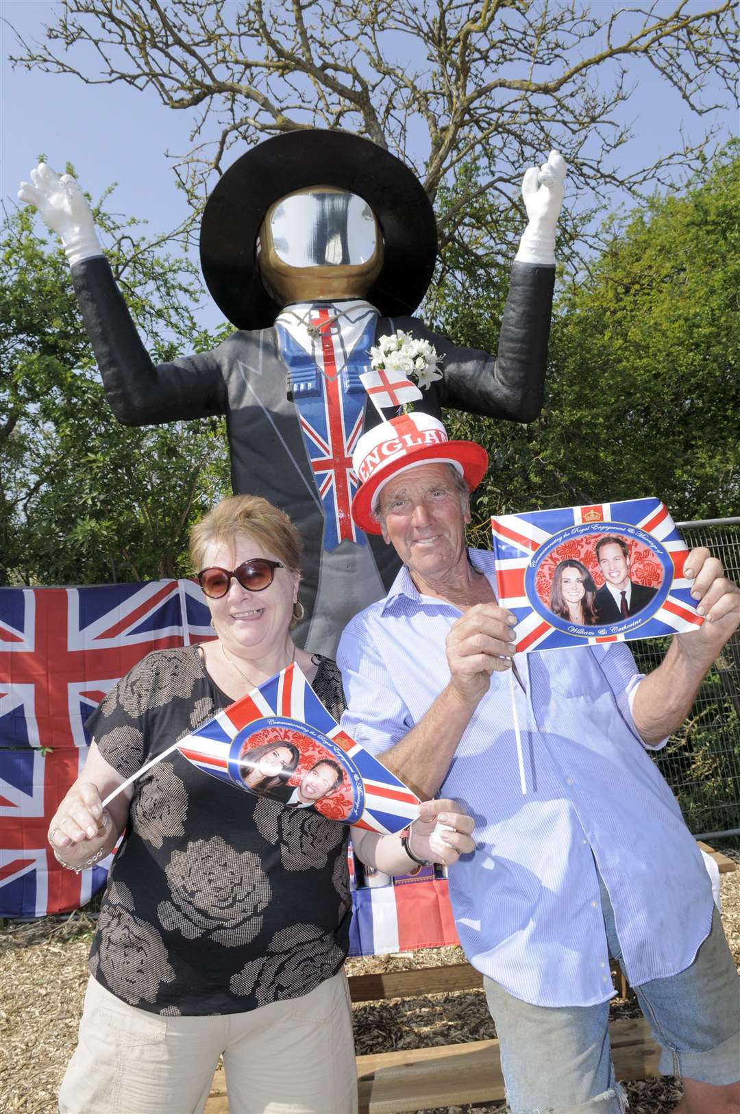 Cllrs Val Harris and Dave Purssord with the Big Man, painted as a groom when he was dressed up for the Royal Wedding in 2011
