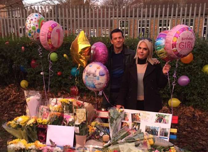 Luna's uncle Junior Rocha and mother Bruna Barros behind the memorial bench which was inundated with floral tributes and birthday balloons