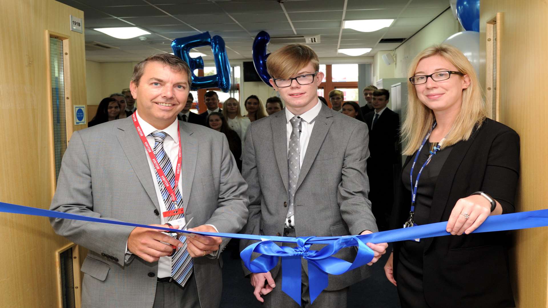 Head boy Sam Goodman cuts the ribbon to declare EA6 open, helped by MP Gareth Johnson and assistant principal Sara Poolman. Picture: Simon Hildrew