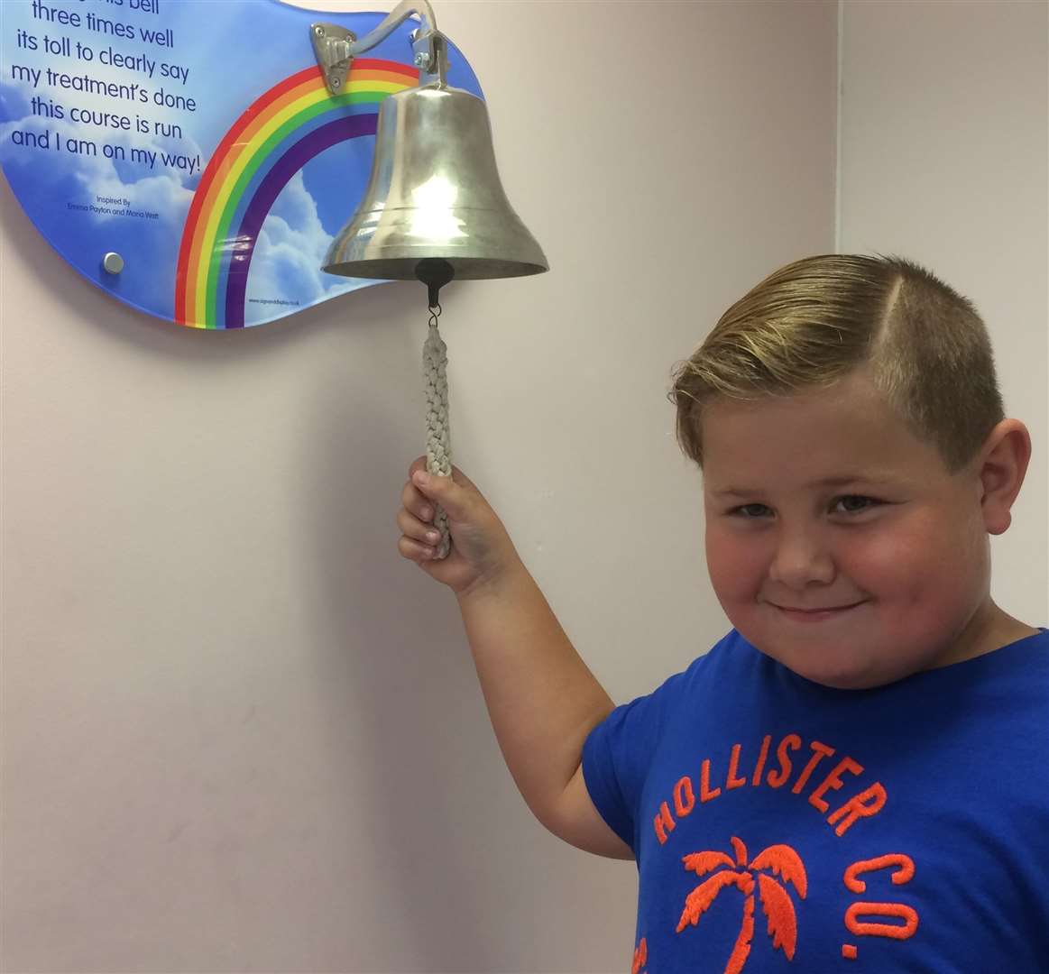 Aaron Lindridge, then aged eight, ringing the End of Treatment bell after five years free of cancer. He is pictured ringing the bell at the Royal Oak Children's Centre at the Royal Marsden in Surrey