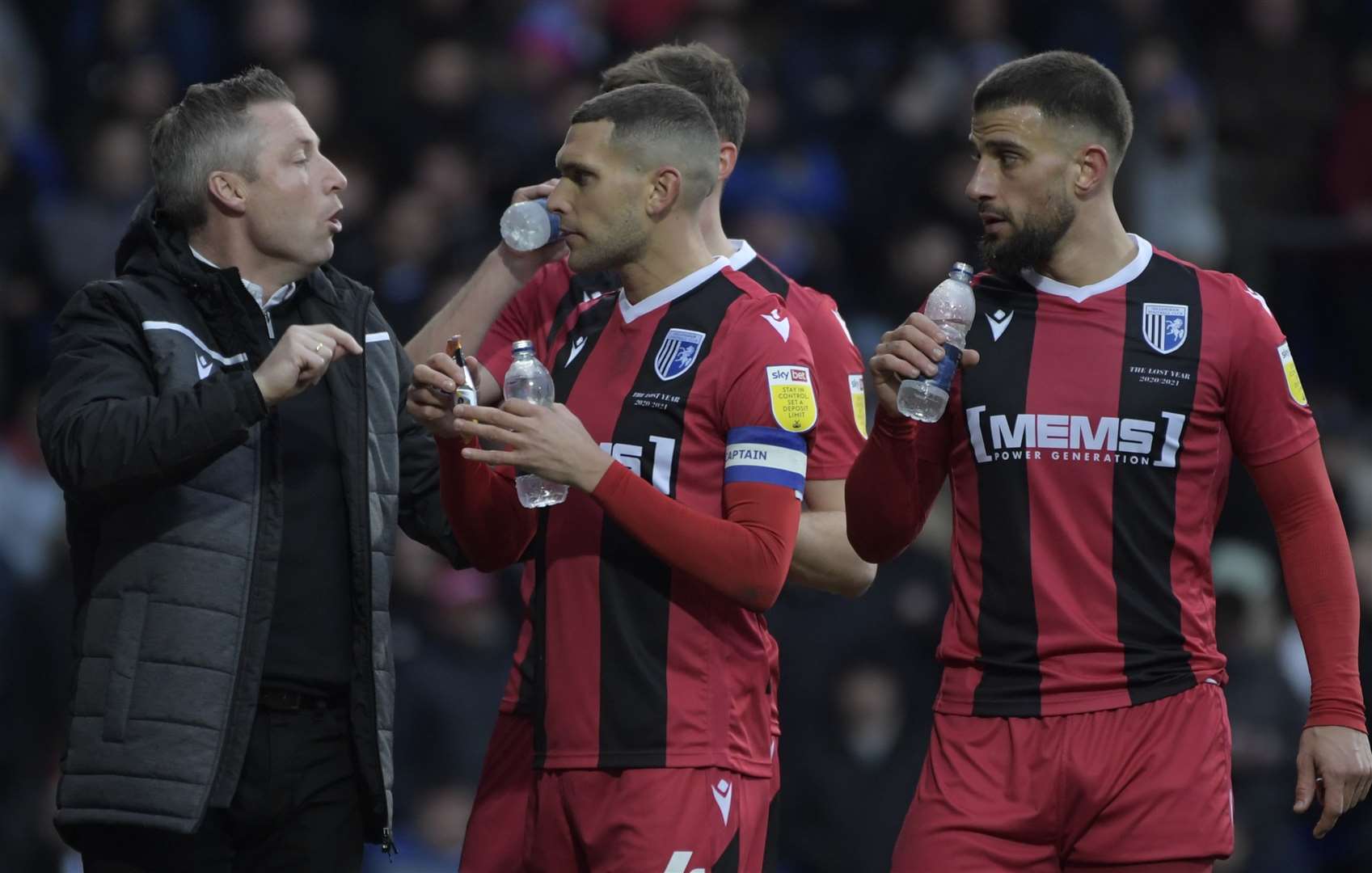 Gills boss Neil Harris talks tactics with his players. Picture: Barry Goodwin
