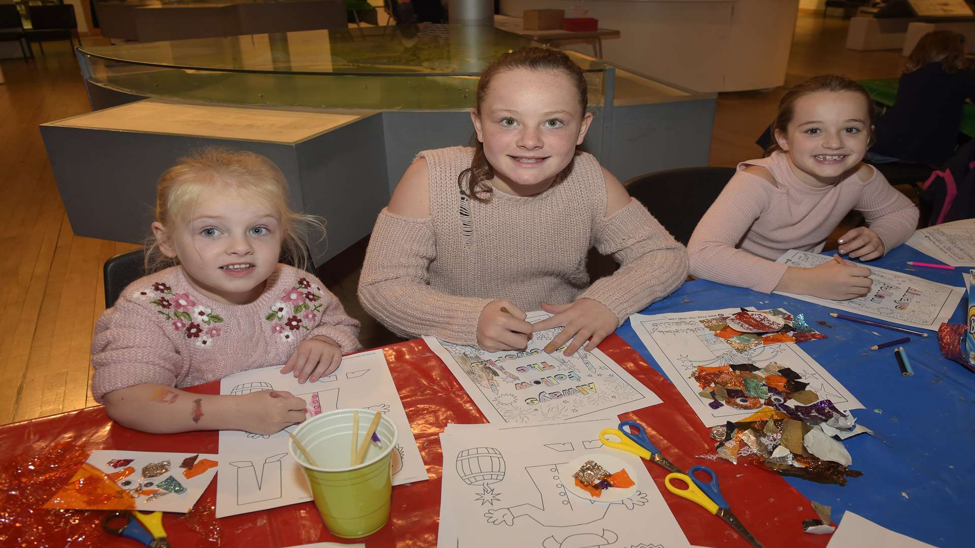 Mille Elder, three, Abby Sedgwick, 10, and Ruby Sedgwick, seven, doing artwork