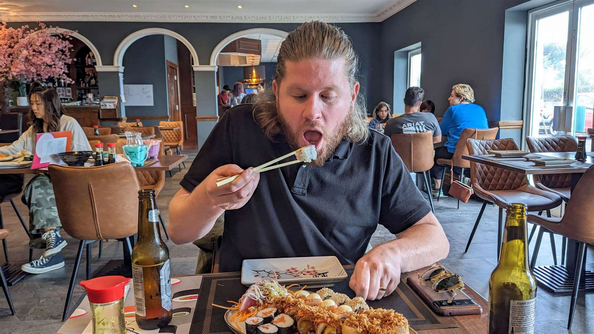 Our man does his best with the chopsticks