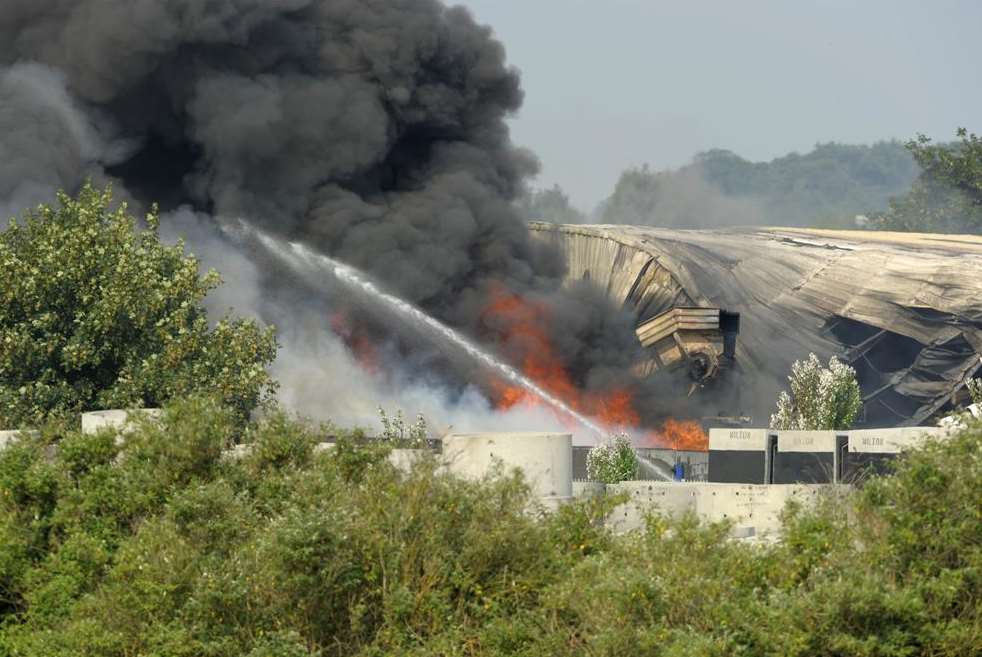 Firefighters douse flames billowing from the Sweep recycling depot. Picture: Andy Payton