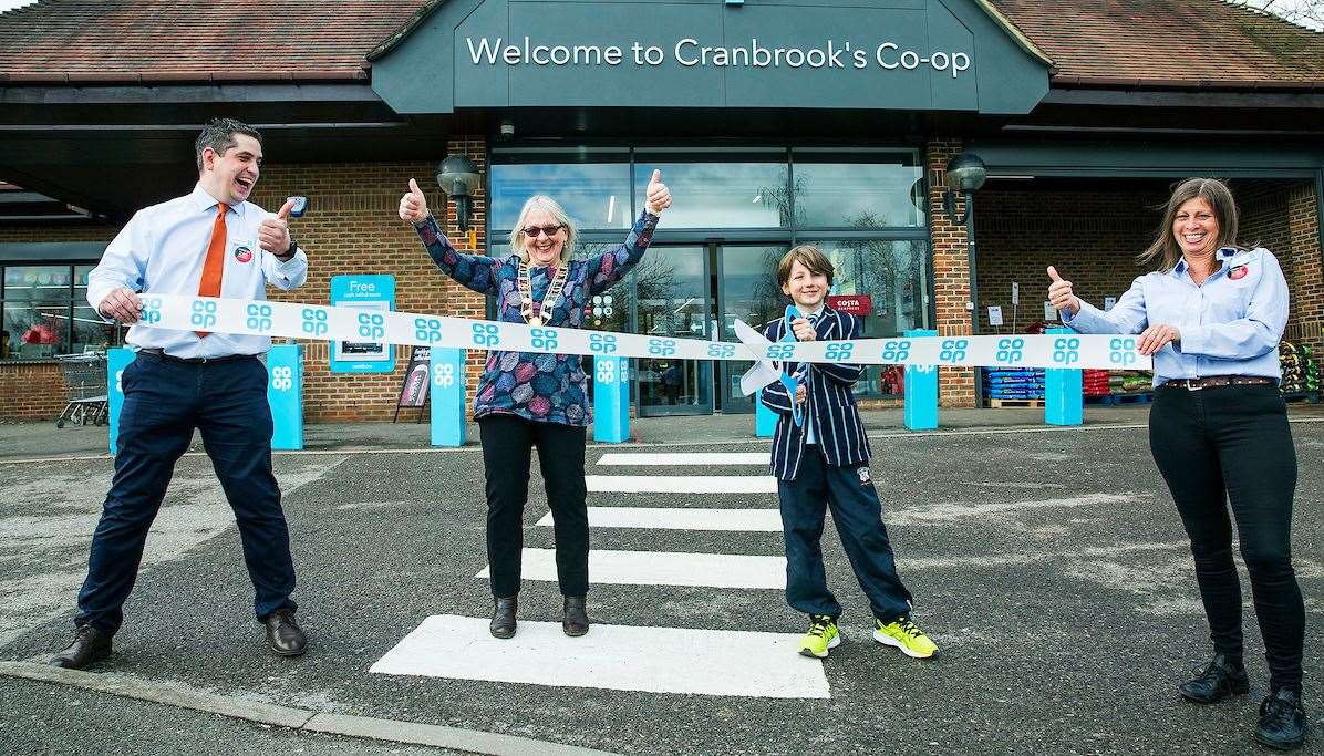 Young artist Rollo Jensen cuts the ribbon with Co-op store manager Laurence Hernandez and Mayor Linda Page. Picture: David McHugh