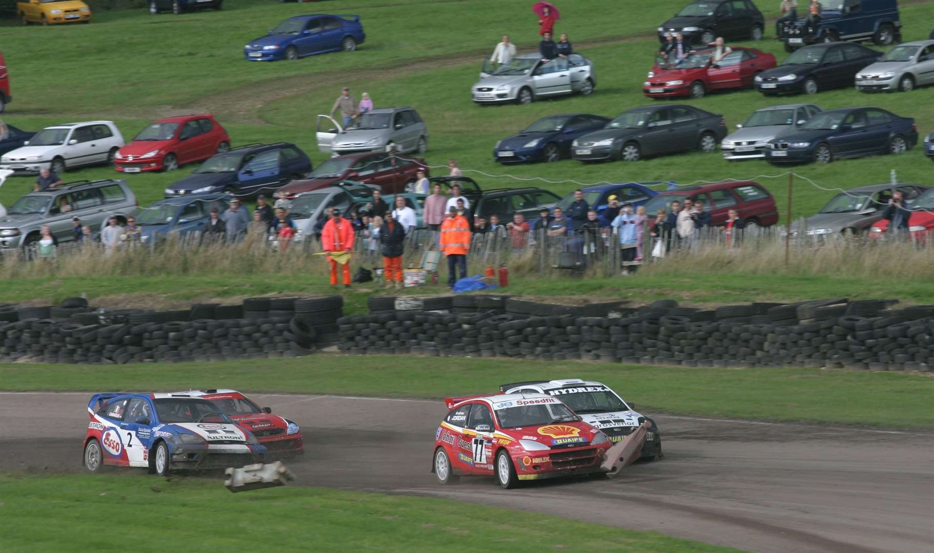 Andrew Jordan (77) sends the course markers flying as he sweeps past Pat Doran, while Dermot Carnegie (2) and John McCluskey dispute fourth place in the British Rallycross 'A' final at Lydden in August 2006. Picture: Kerry Dunlop