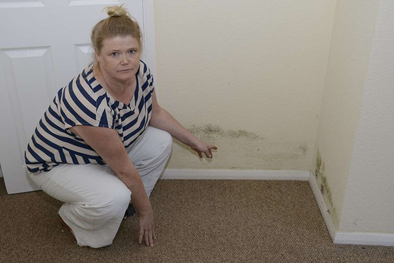 Amanda Joynson points out the Damp and mould after the flood