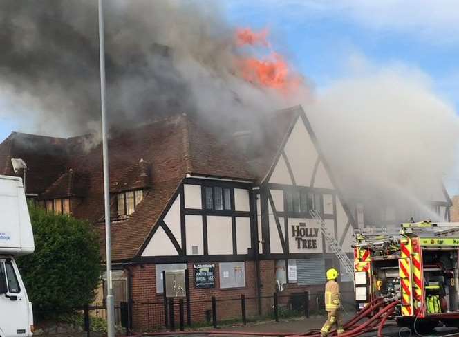 Flames have engulfed the roof of the pub. Picture: Ian Pulman