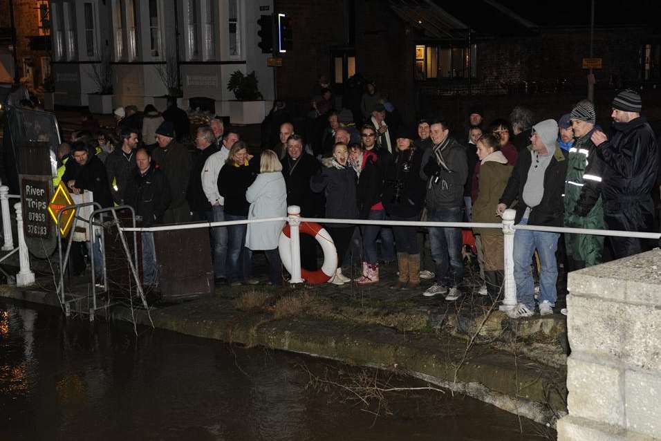 Residents in Sandwich gather as waters rise in the town. Picture: Tony Flashman