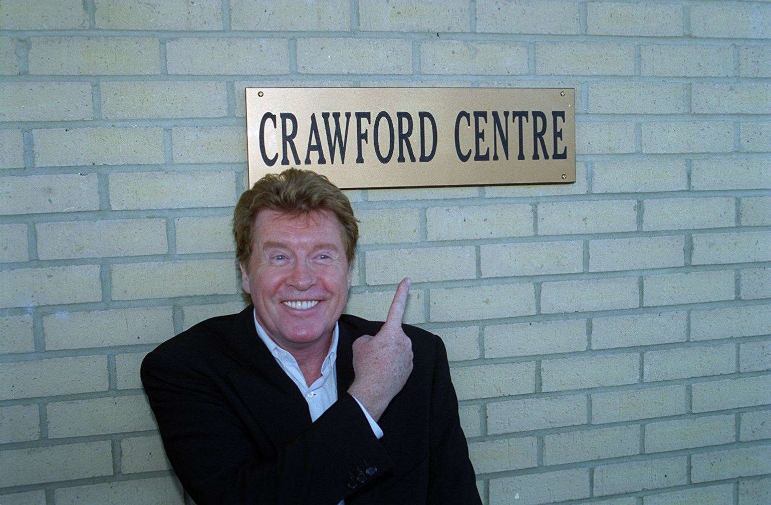 Ann Everett invited West End star Michael Crawford to return to the Island to open the Crawford Centre in November, 2001