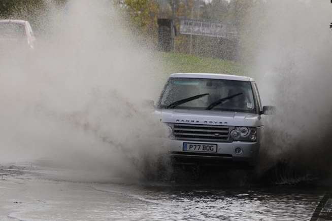 A car makes a splash getting through flooded Willesborough Road. Library picture