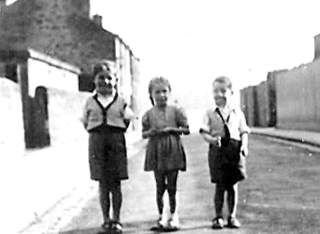 The 60-year-old photograph posted on Facebook that led to the reunion of Allan Healy, pictured right, aged seven, with his sister Margaret (centre)