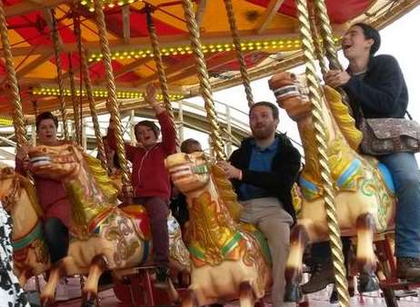 Some of the first visitors enjoy the Gallopers