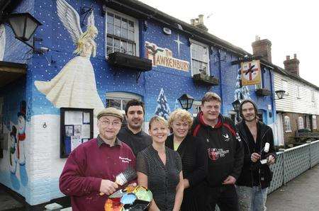 Pub staff and mural artists outside the Hawkenbury