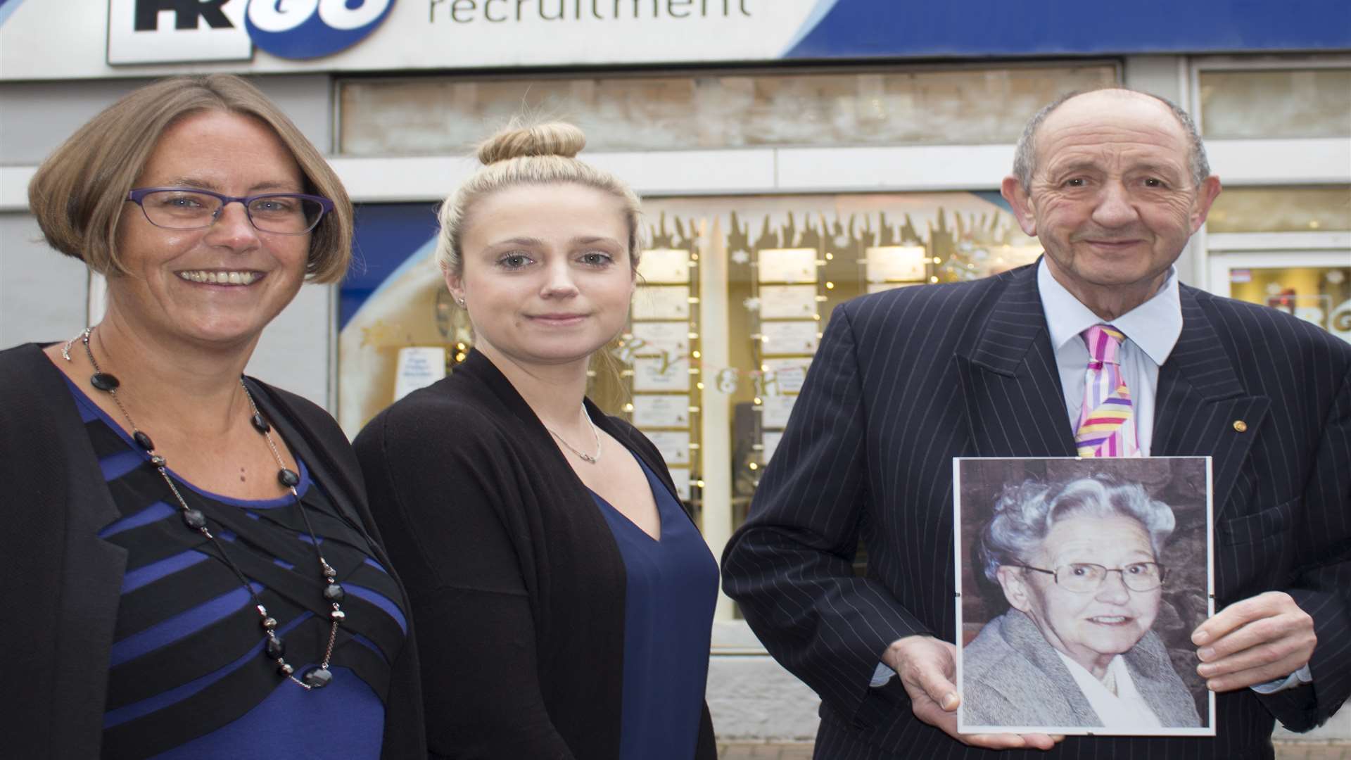 Chairman Jack Parkinson with a photo of Betty, his late mother and company founder, outside the branch in Dartford where the business began, with branch manager Lucy Andrew, left, and commercial consultant Samantha Foster