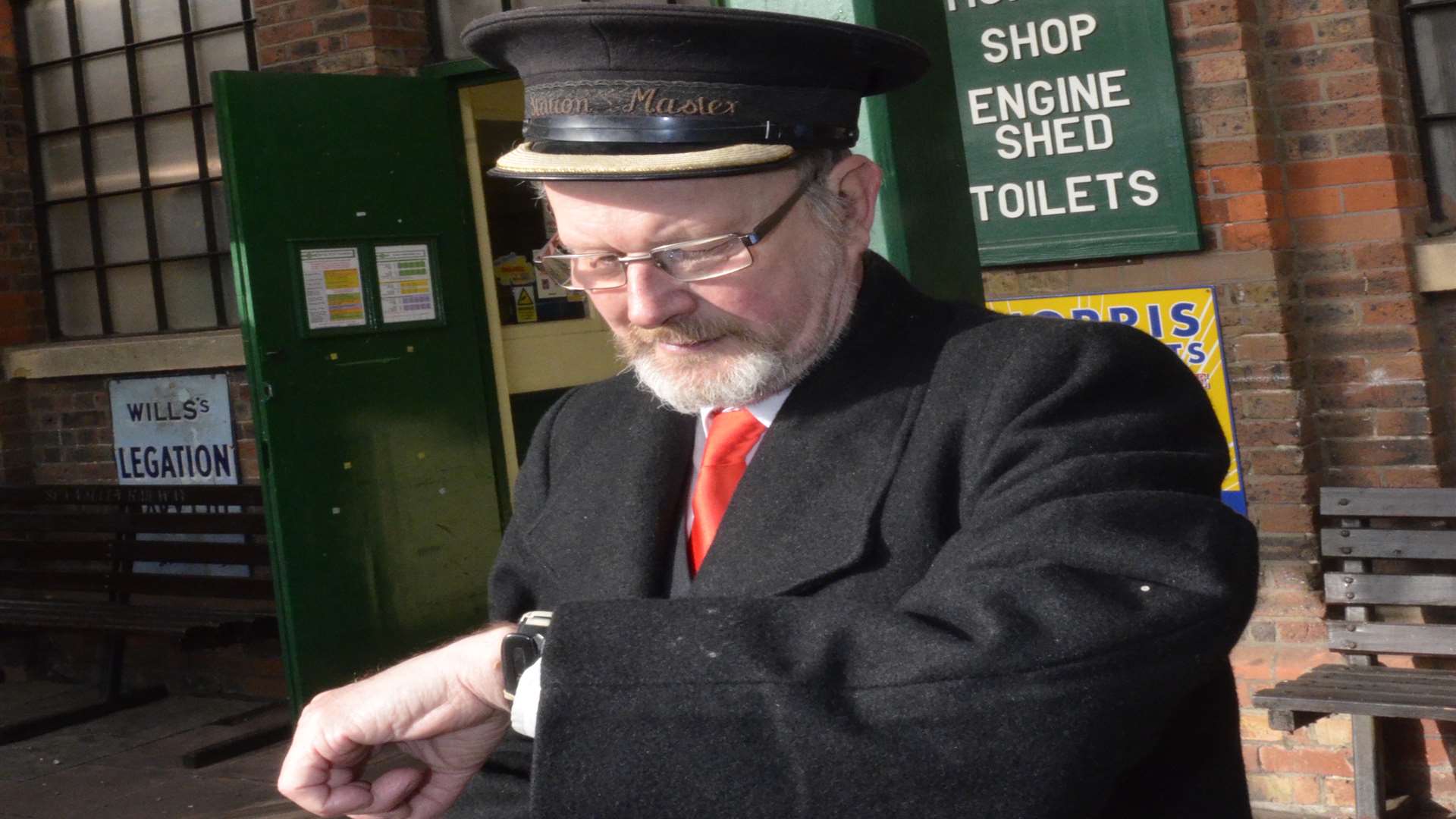 Station manager Brian Halford checks the time of the next train to arrive at the Spa Valley Railway at Tunbridge Wells