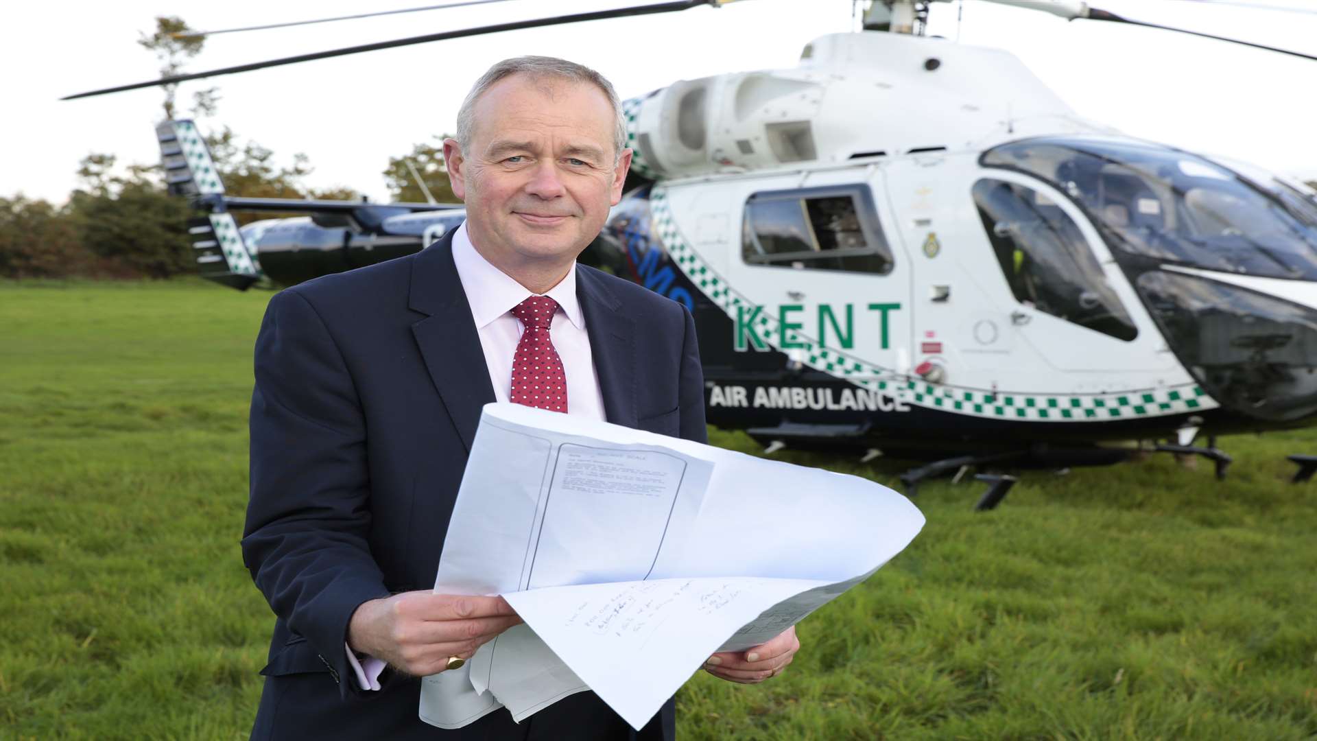 Air ambulance chief executive Adrian Bell with plans for the Paddock Wood site, which have now been shelved