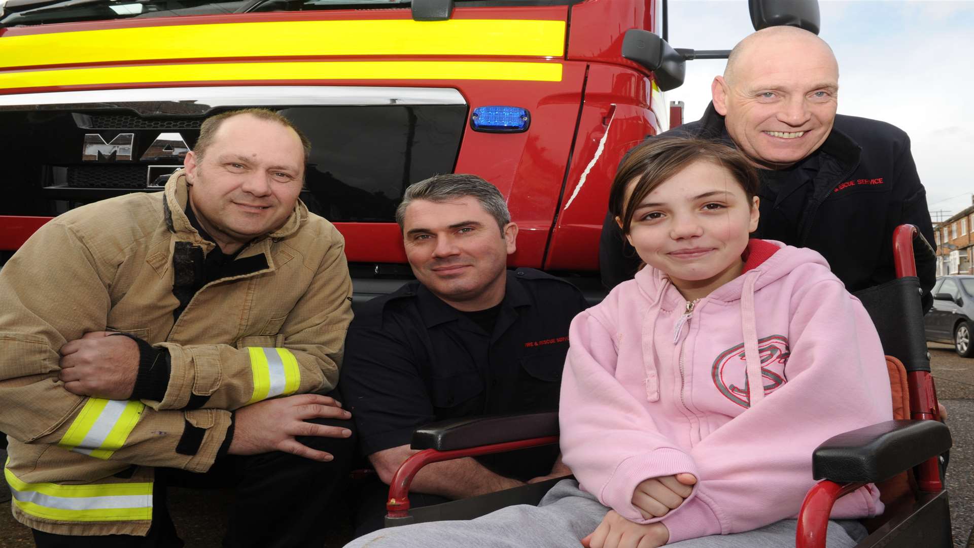 Paige Boyes,12, with firemen Neal Dwyer, Nick Bate, Alan Brown
