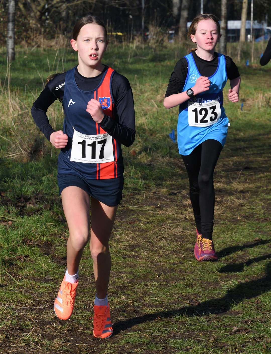Harriet Brooks (No.117) and Maisie Kemp (No.123), both of Thanet, battle in the Year 7 girls' race. Picture: Simon Hildrew (62005831)