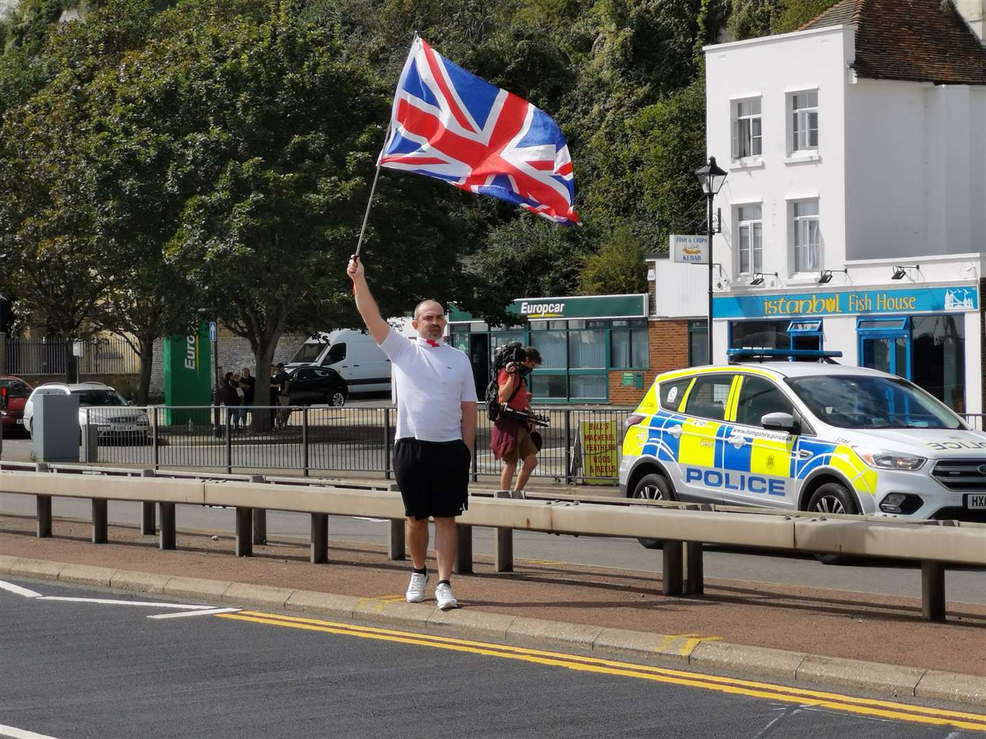 A man waves his flag. Picture: Oliver Kemp
