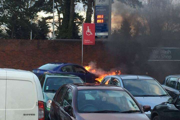 The car on fire in the Tesco car park in Ashford. Pic from Jessica Davies