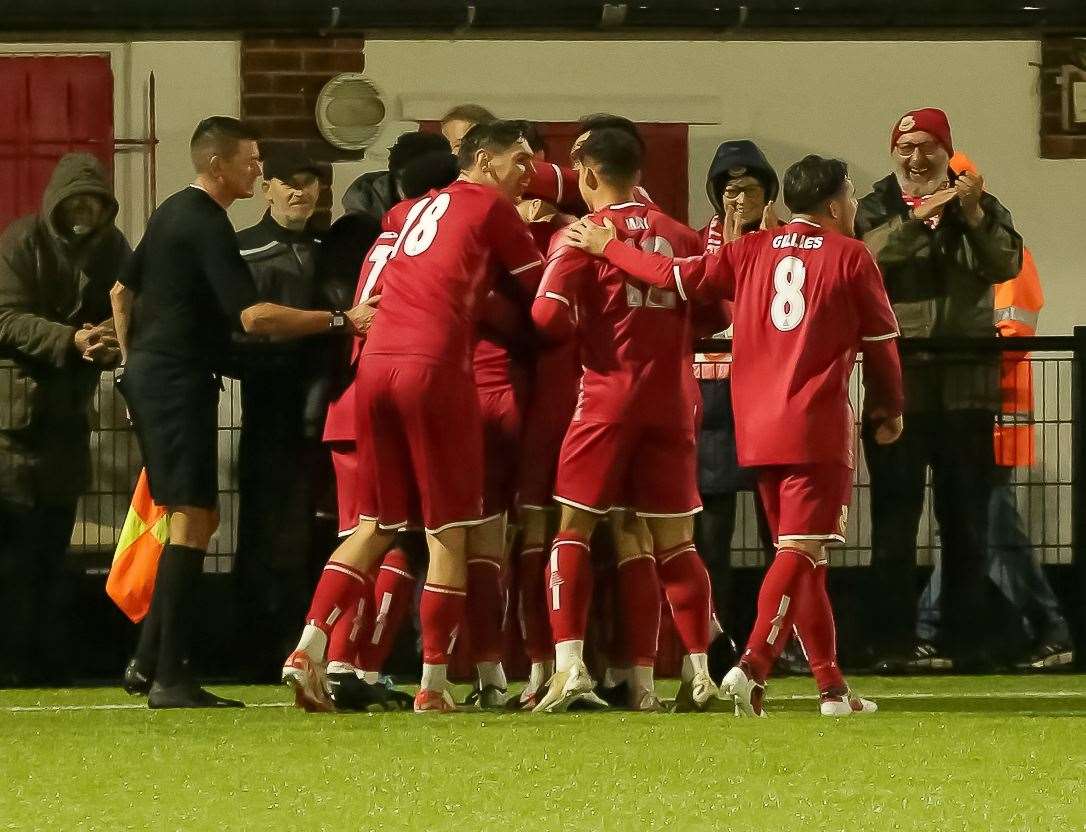 Jake Mackenzie celebrates with his Whitstable team-mates. Picture: Les Biggs