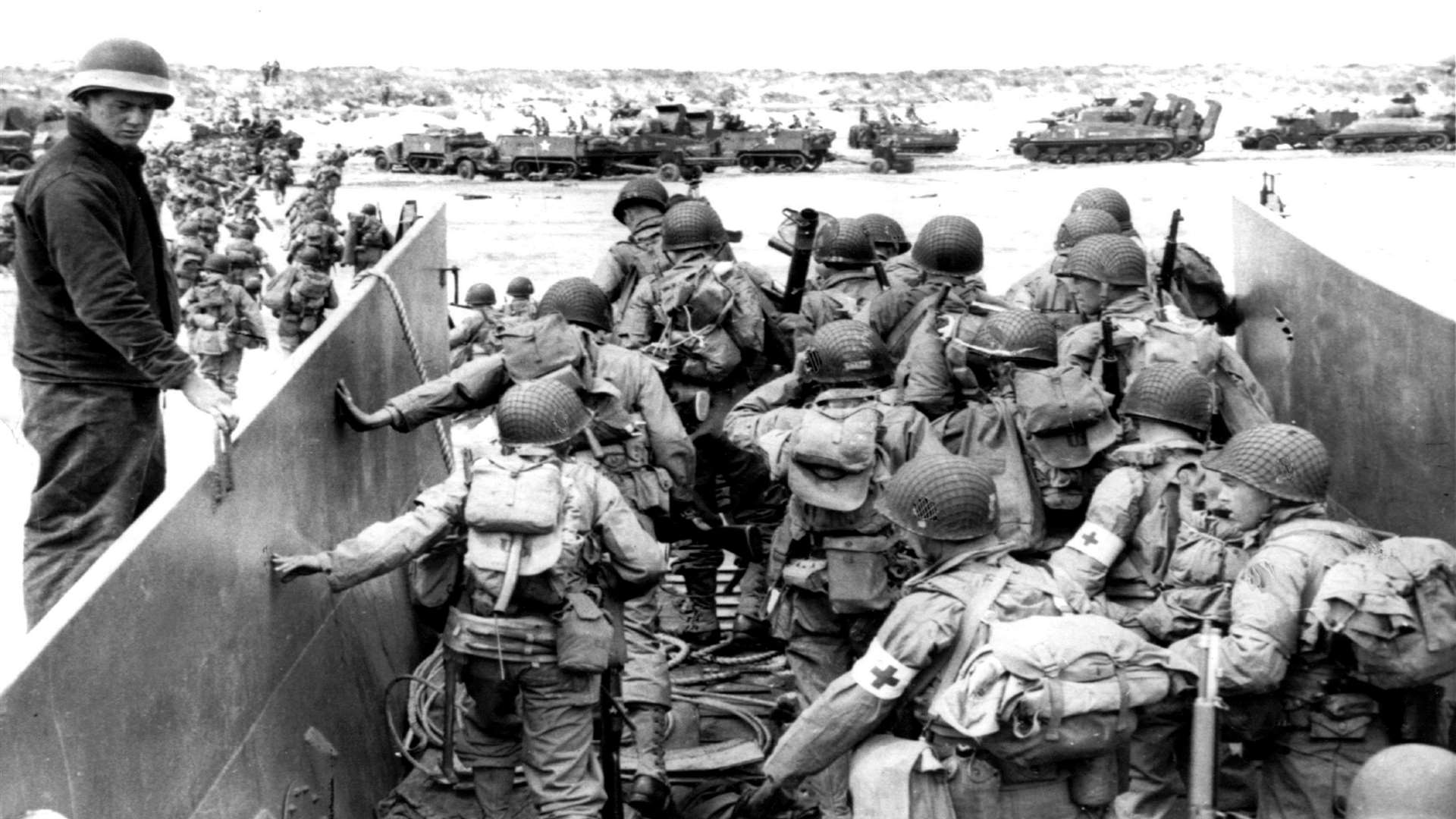US Army soldiers disembark from a landing craft during the Normandy landings
