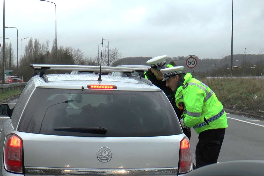 Police pull over a driver near Audi on the Running Horse roundabout