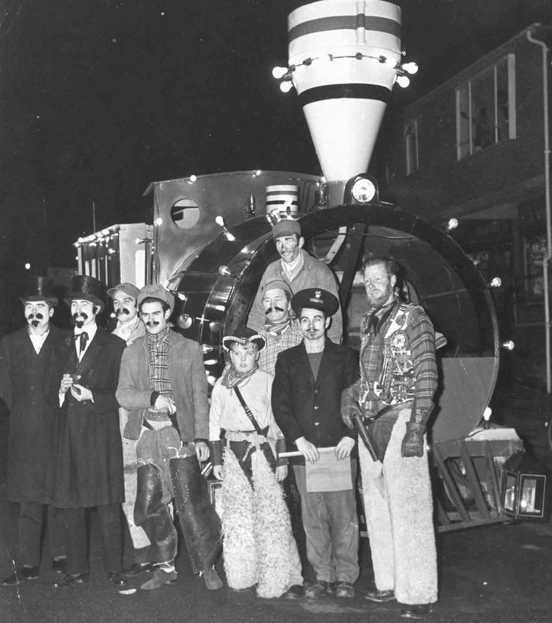 Children's Day was a major pre-Christmas tradition in Ashford High Street when families turned out in their thousands to greet the arrival of Father Christmas. Here staff from Crouch's Garage pose with their 1962 float entry. Picture: Images of Ashford by Mike Bennett