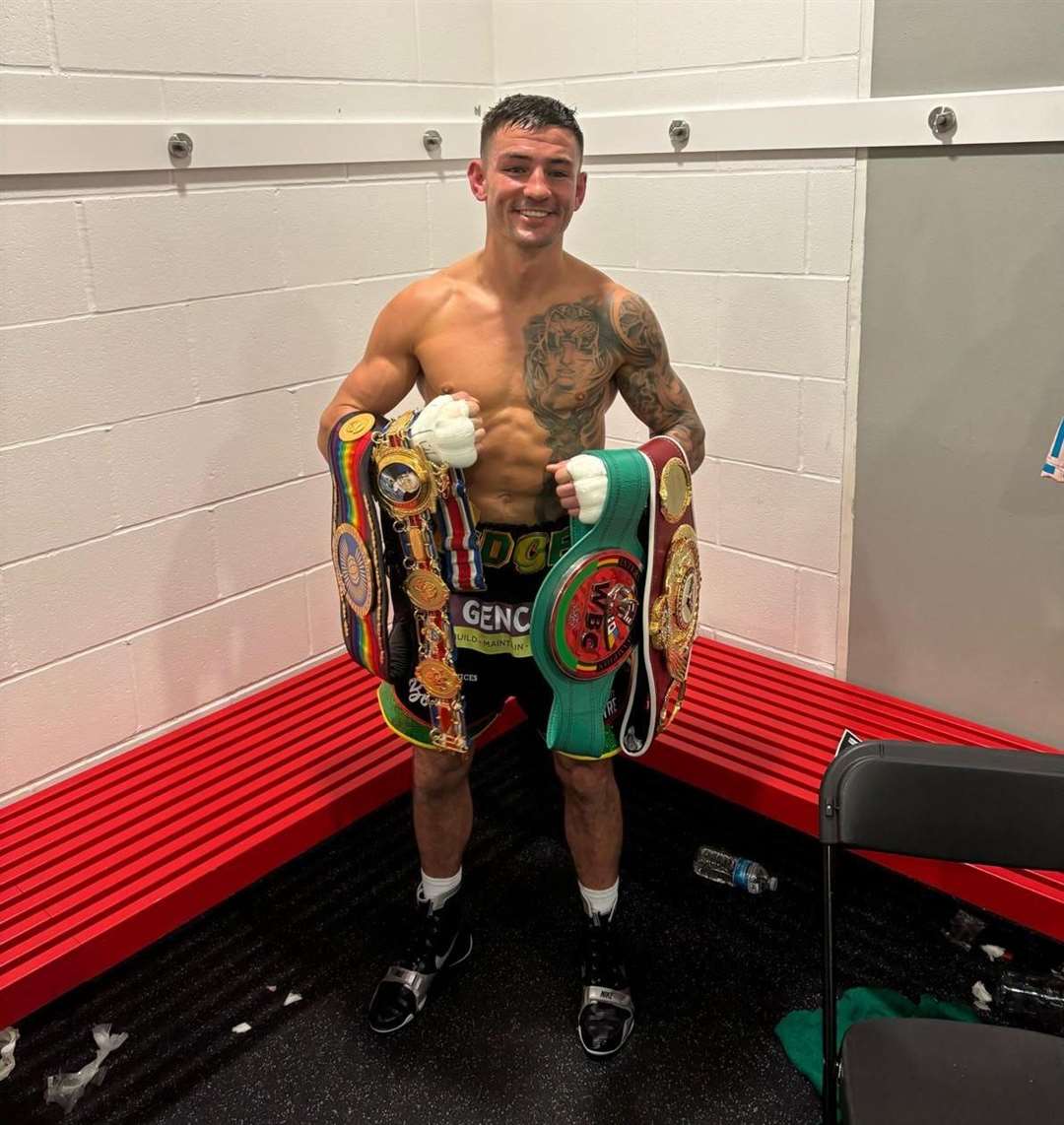 Maidstone boxer Sam Noakes with his collection of belts.