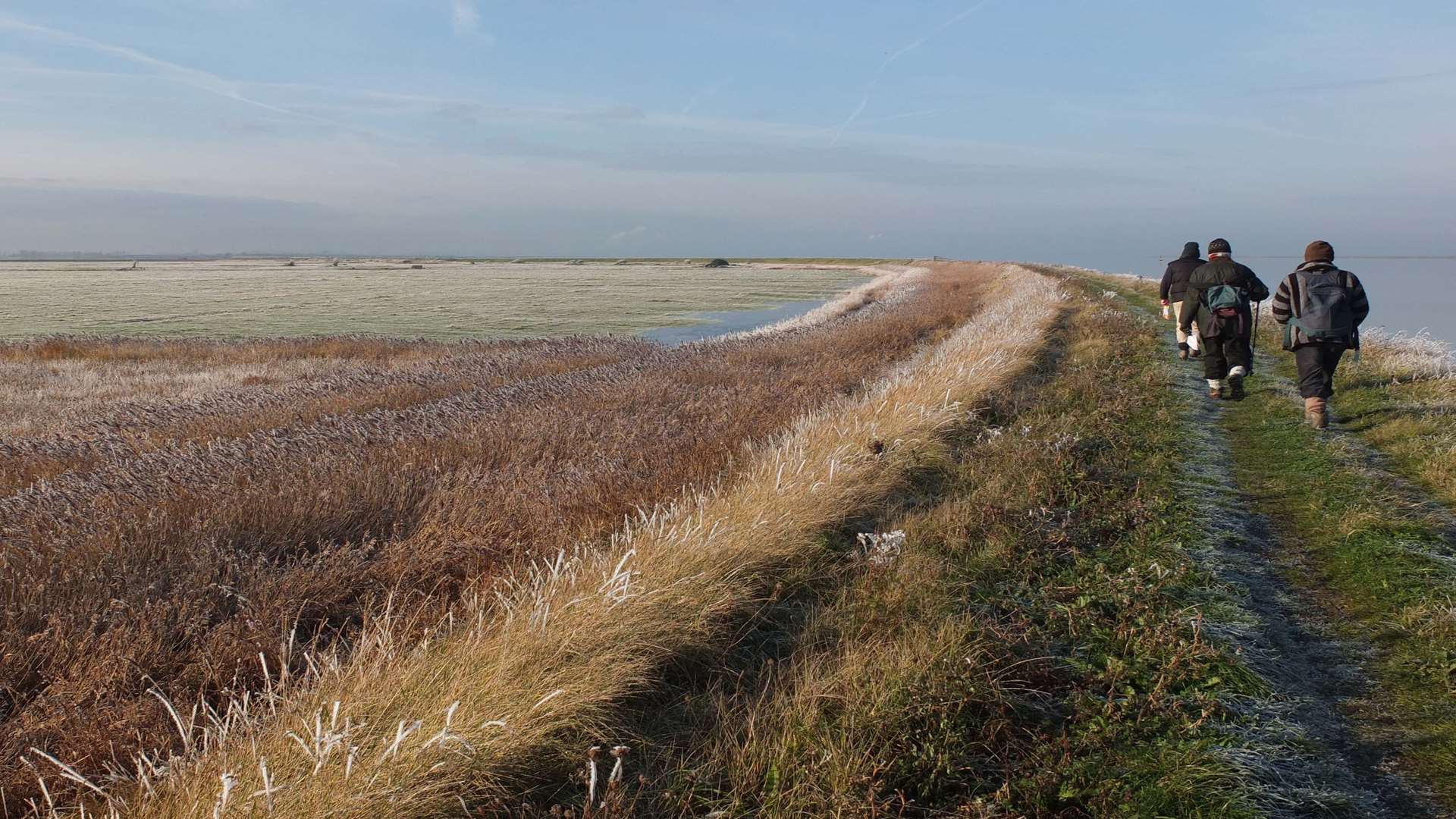 Coastal path: walkers along waters' edge of The Swale between Oare and Conyer. Picture: Stewart Miller.